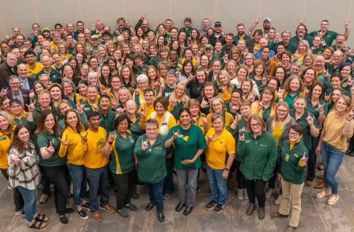 A large group of people giving wearing either NDSU green or gold