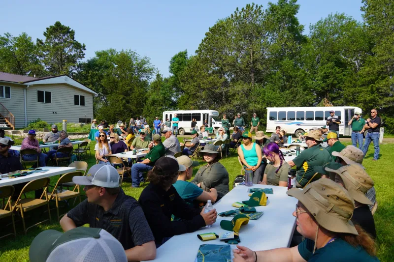 people at tables outside at a field day